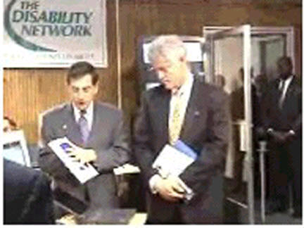 Television photo of Steve Jacobs and President Clinton discussing the business bebefits of accessible IT design.